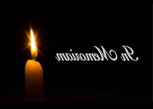 Image of candle burning in black background